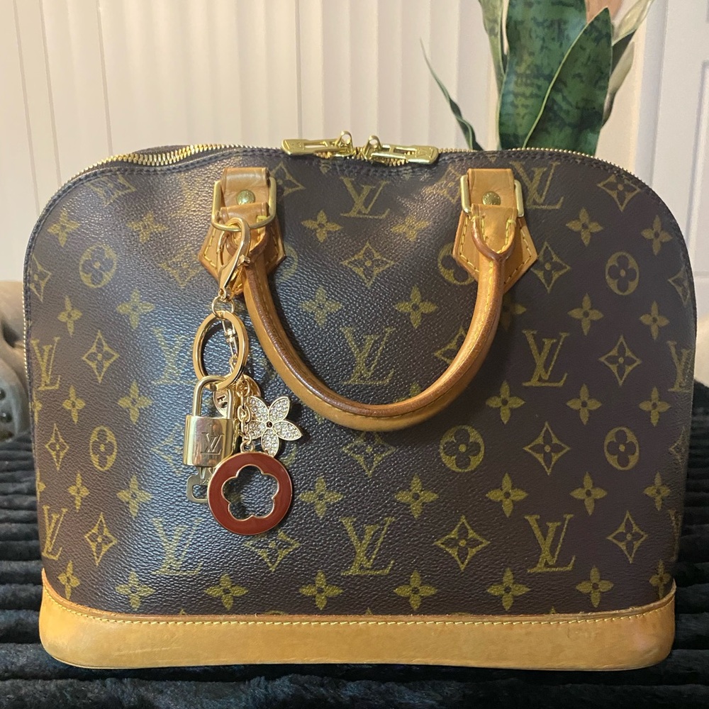 Authentic w’ COA. Louis Vuitton Large Alma PM Monogram bag with charm.